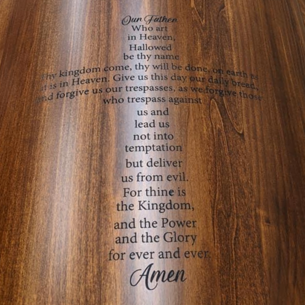 &Quot;Our Father&Quot; Prayer Laser Engraved In A Cross Shape On A Wooden Casket.