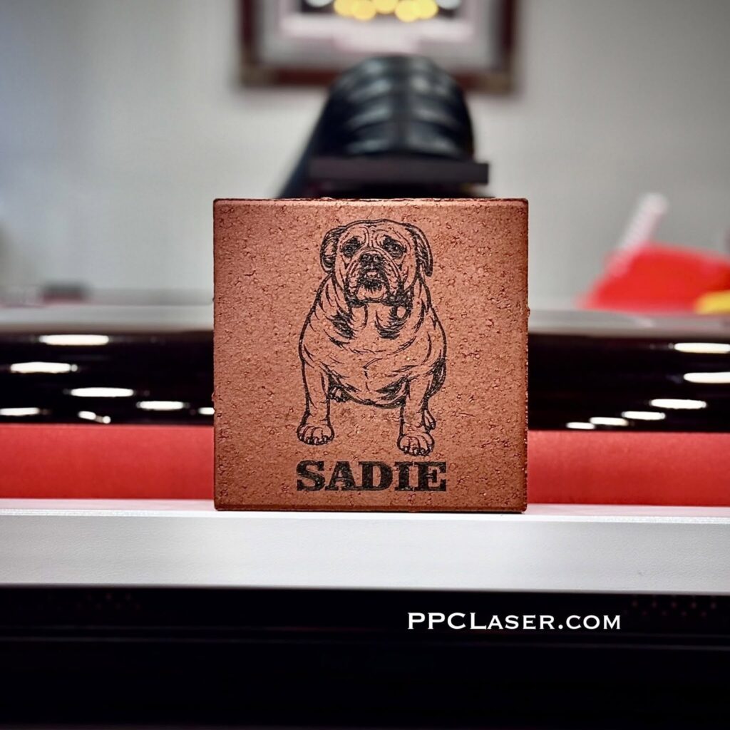 photo of a laser engraved red clay paver brick with an image of a pet dog on it.