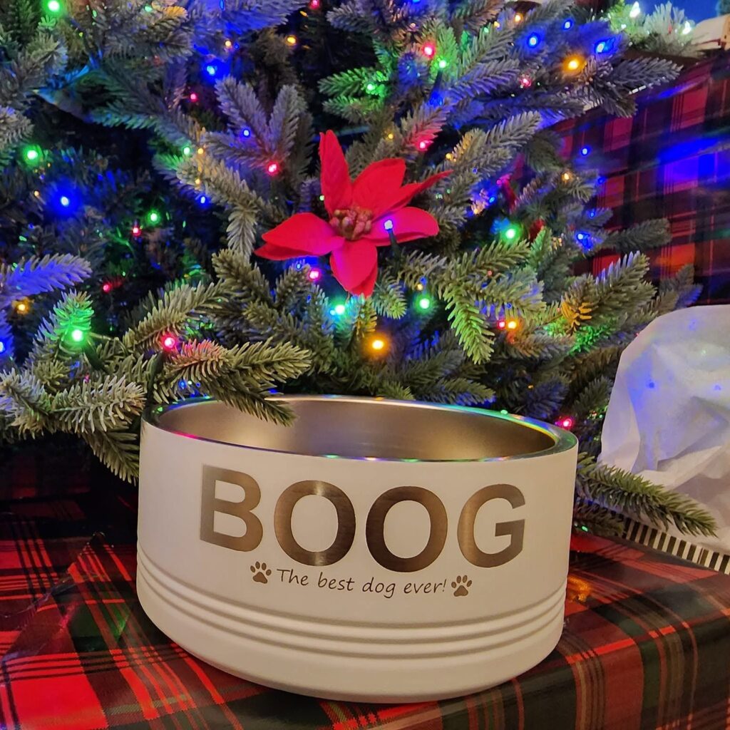 A staged photo of a stainless-steel dog bowl, which has been engraved as a Christmas gift.