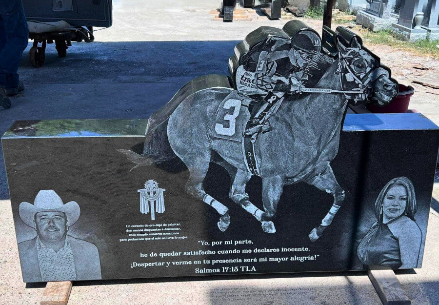 Granite memorial engraved with images of a horse racer, a man in a cowboy hat, a woman, and a quote from Psalms 17:15 TLA.
