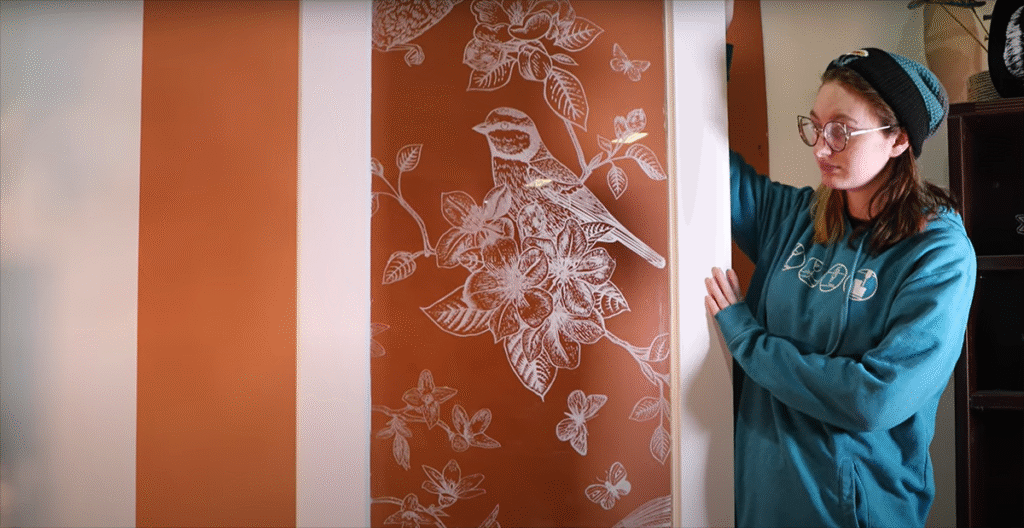 Close-up shot of a glass door engraved with a intricate nature scene.