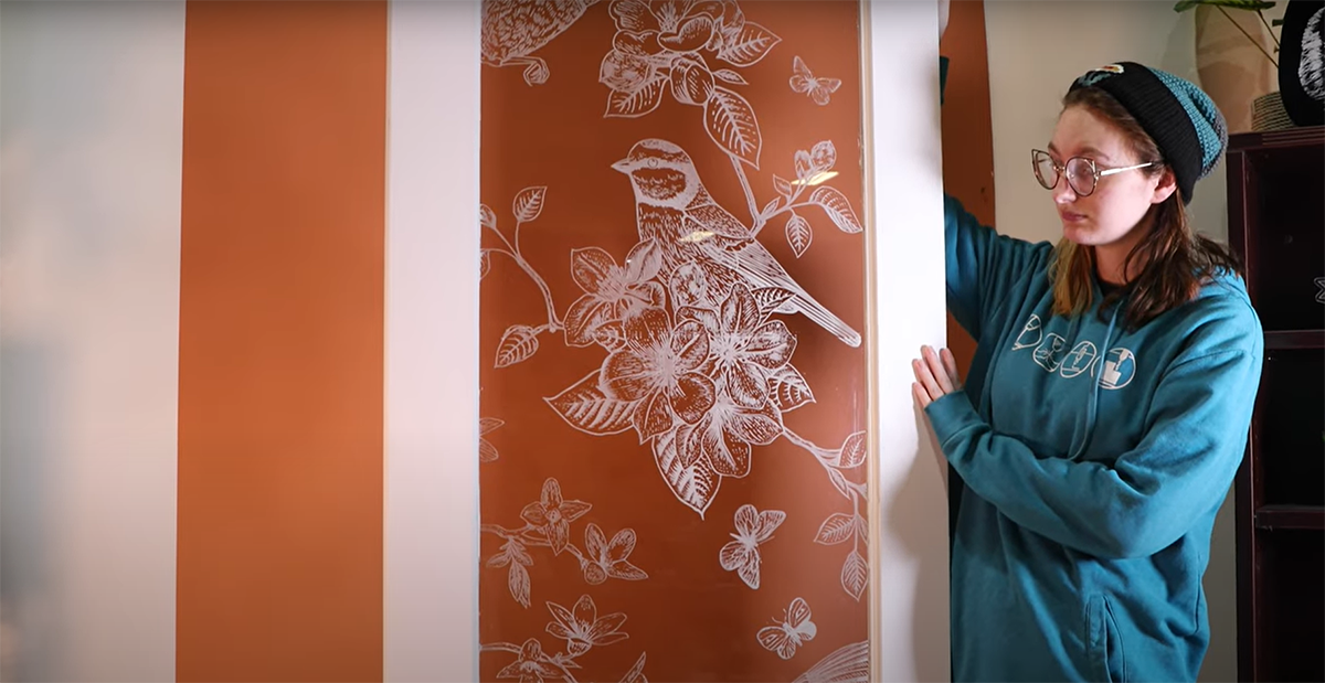 Close-up shot of a glass door engraved with a intricate nature scene.