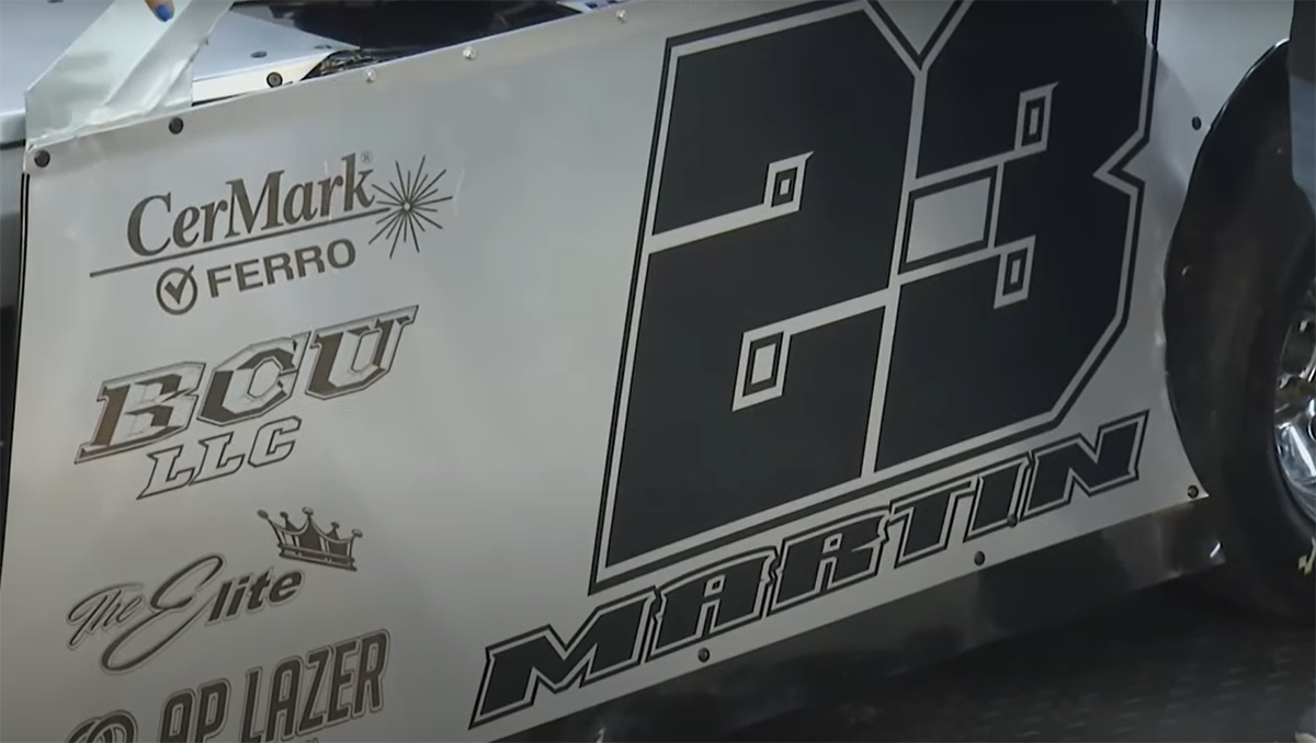 Close-up of laser engraved metal racecar door.