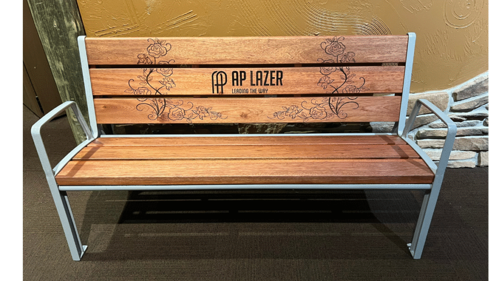 Laser-engraved wooden garden bench featuring AP Lazer logo and floral design.