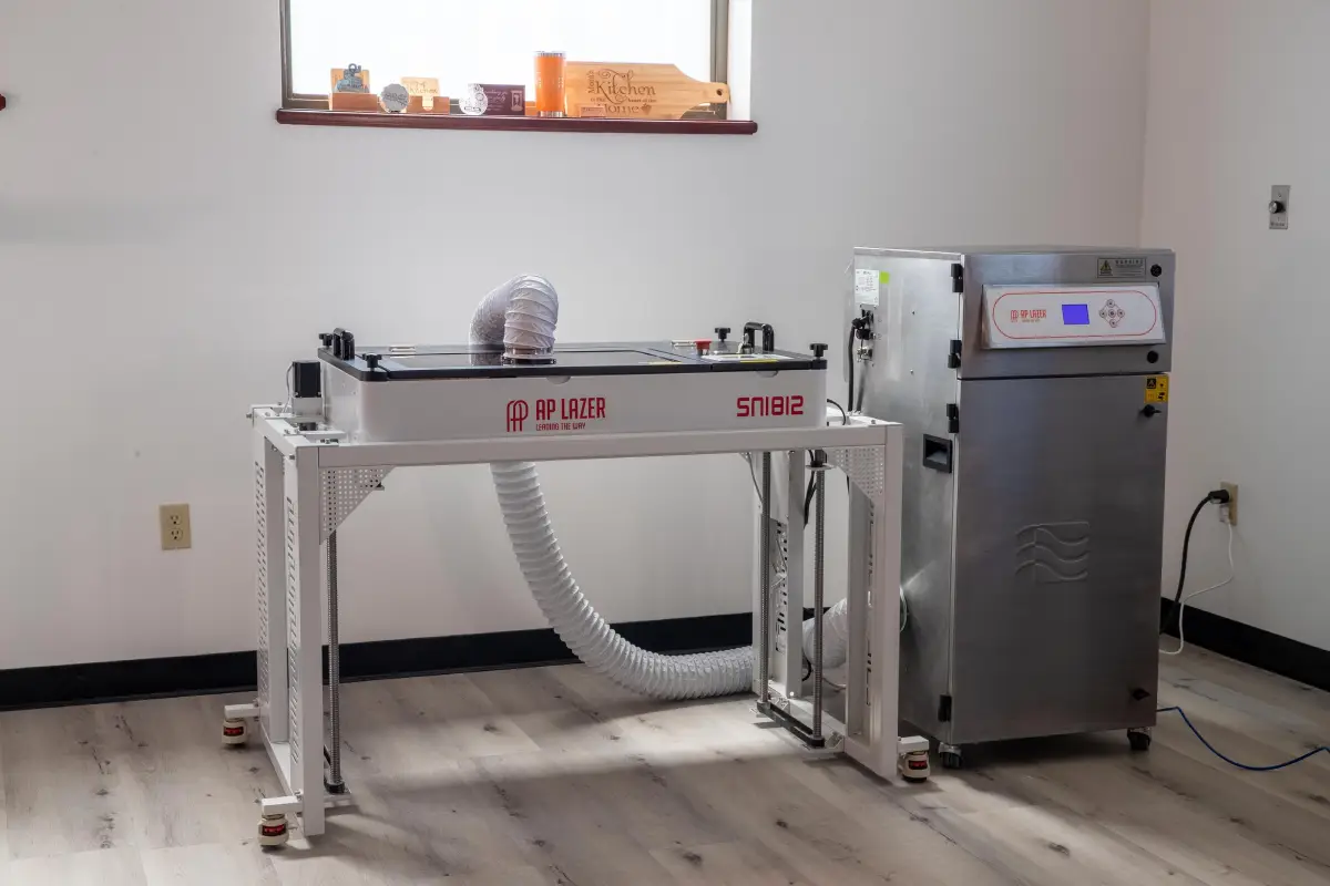 Laser engraving machine setup in a clean, modern room.