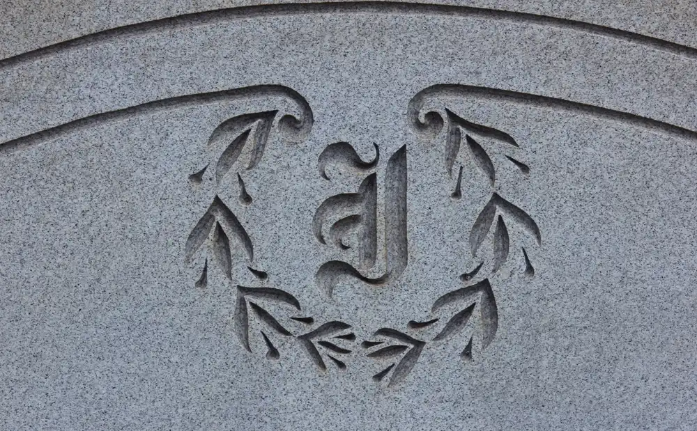 A granite headstone ornately engraved by a laser engraving business.