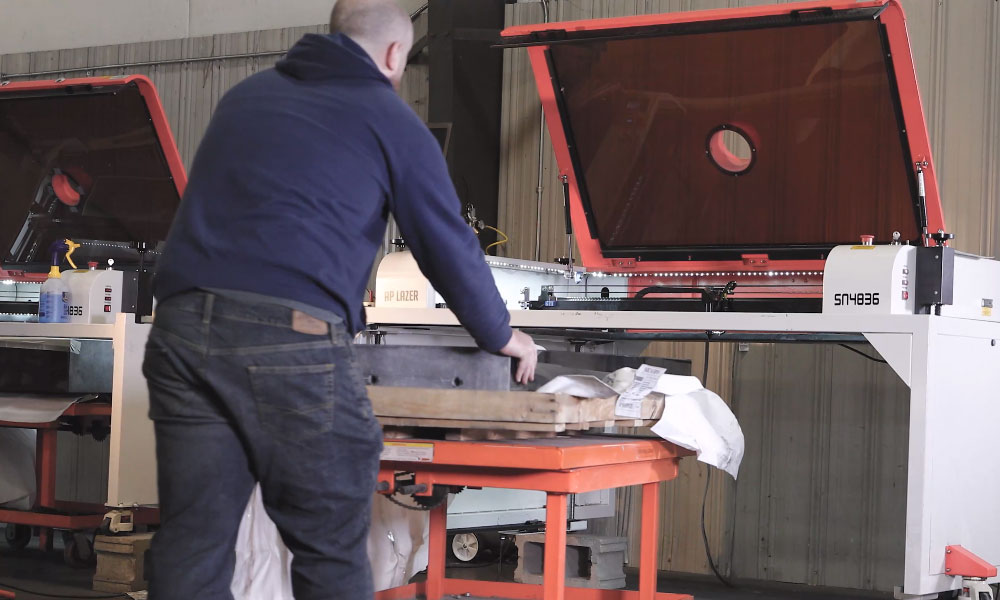AP Lazer machine engraving a large granite memorial stone