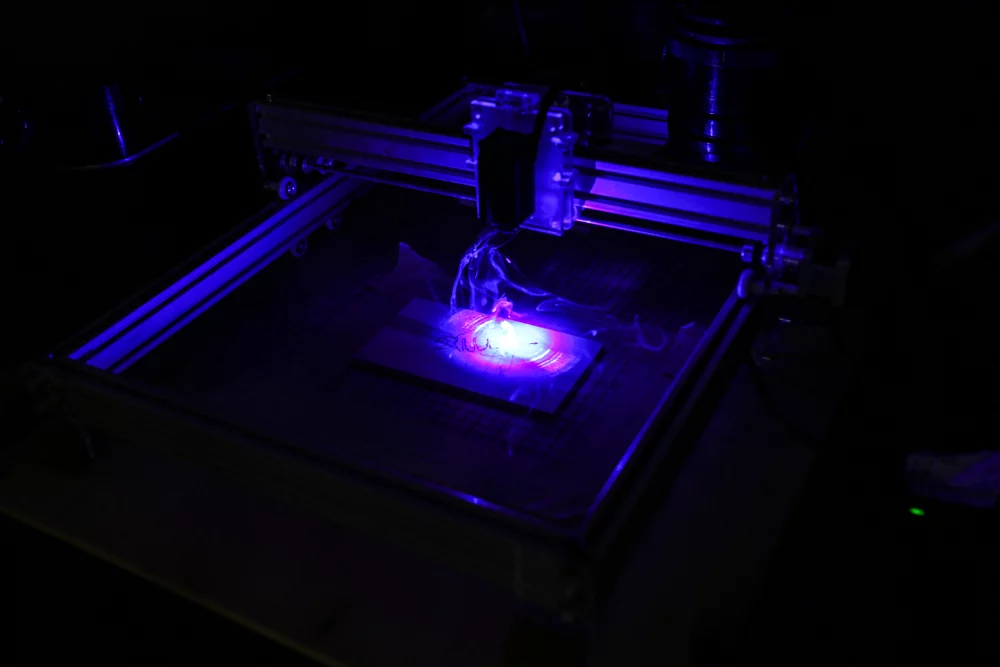 A laser engraver in the dark.