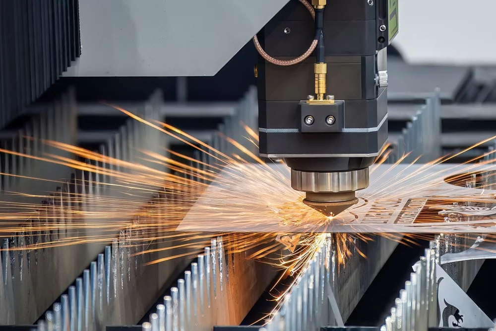A laser cutting, with sparks flying.