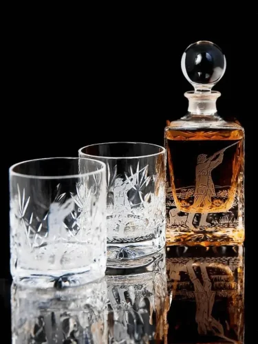 Engraved glassware set, featuring two glasses and a whiskey decanter with intricate designs