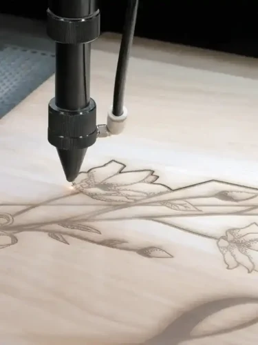 laser engraving floral pattern on wood